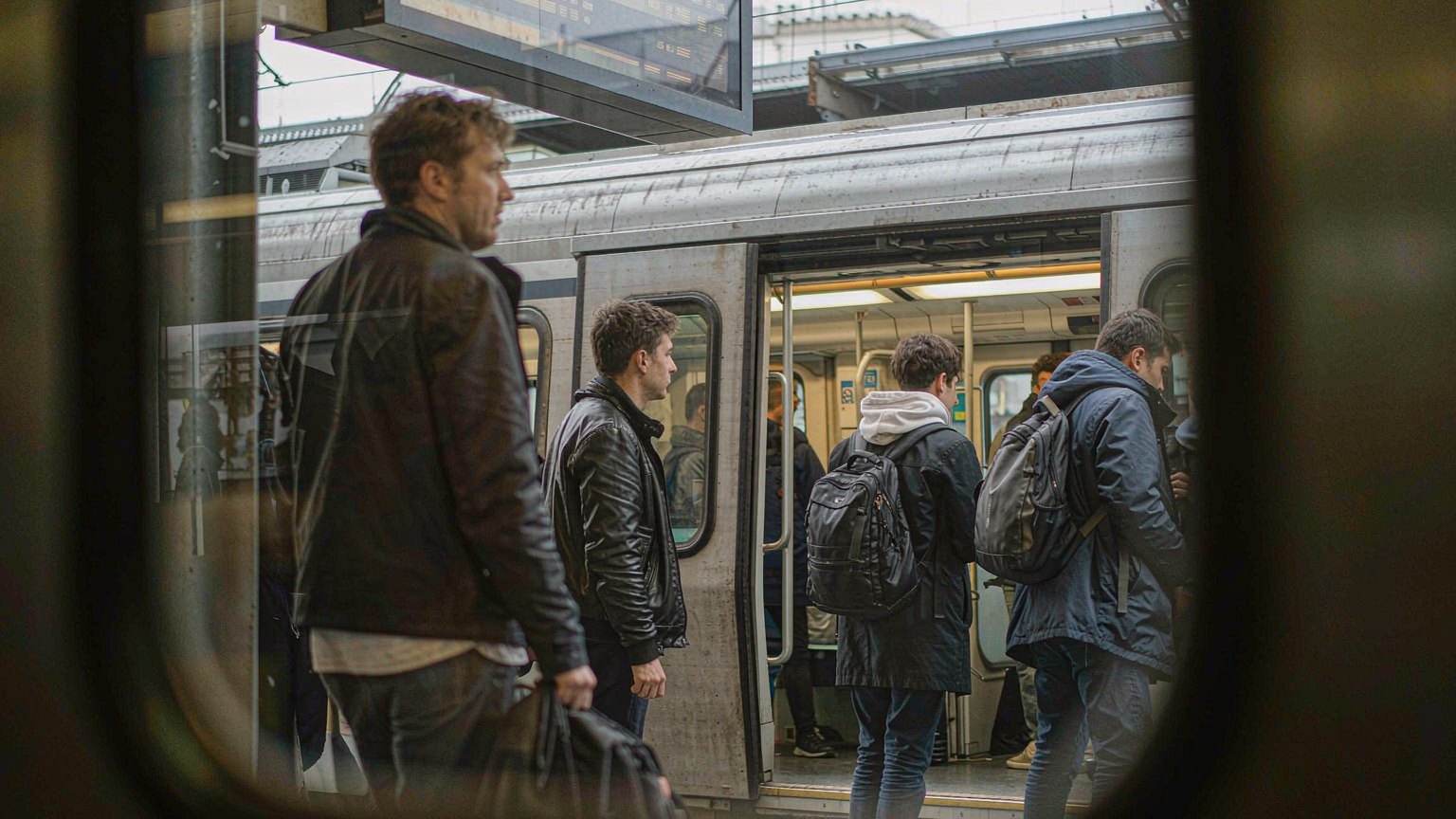 Busy railway station platform with commuters